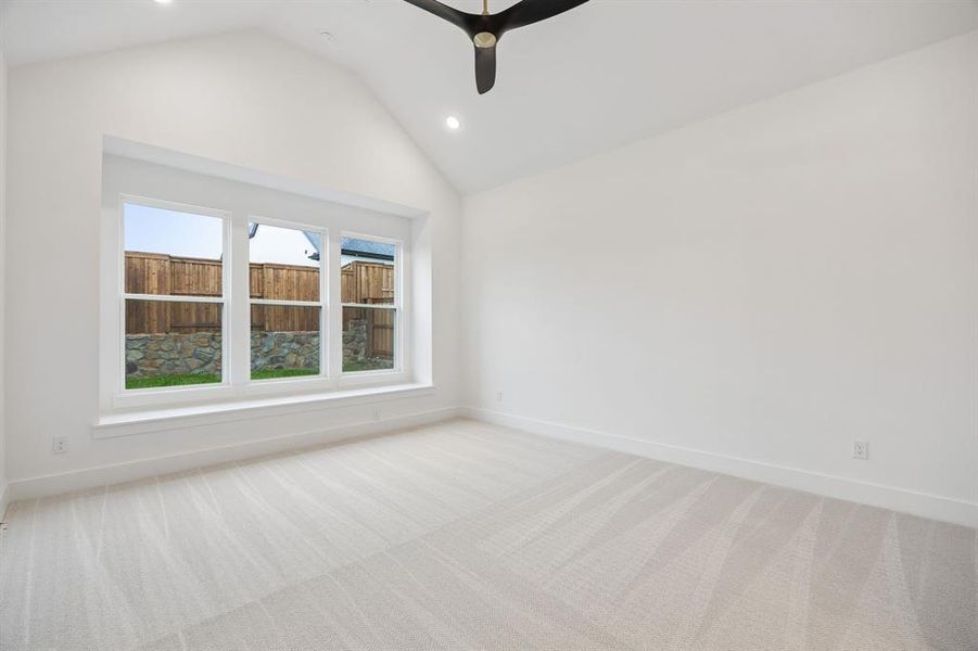 Rest and relaxation await in this dreamy owner's suite featuring built in window seat, high ceilings and plush carpet.