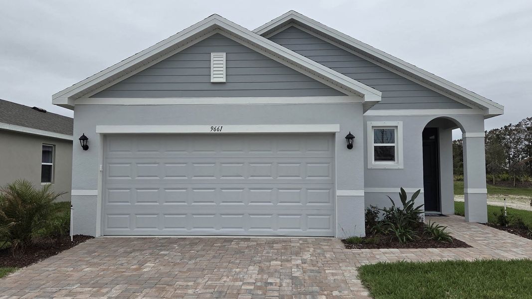 Front exterior of a new home in Venetian Grove, Vero Beach, FL, highlighting curb appeal (Image 1). Front exterior of a new home in Venetian Grove, Vero Beach, FL, highlighting curb appeal (Image 1).