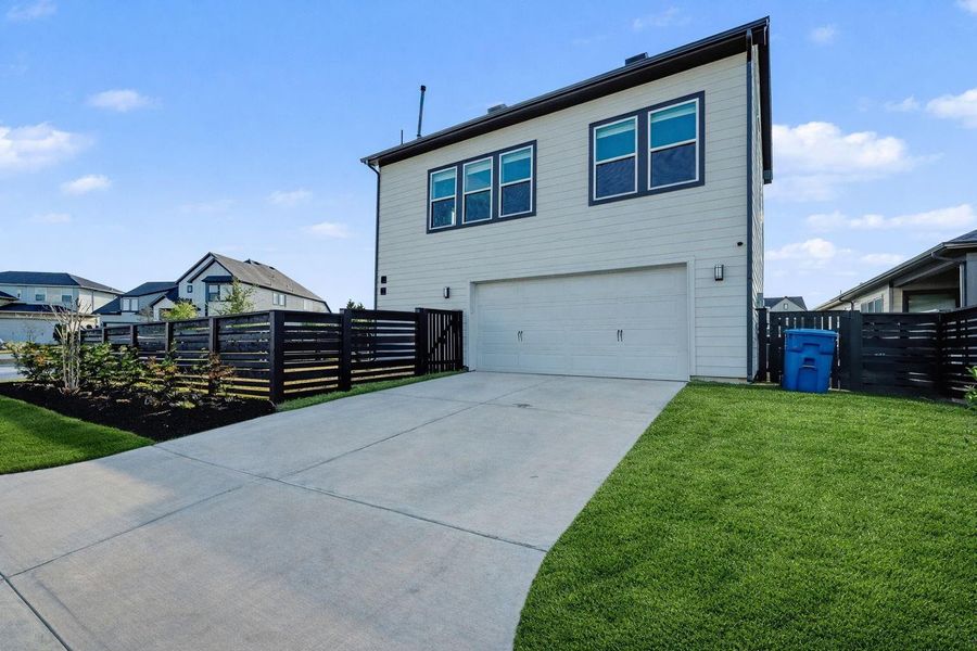 Rear-loading two-car garage with a full-length driveway and private access to the garage apartment, offering added convenience, functionality, and flexible living options.