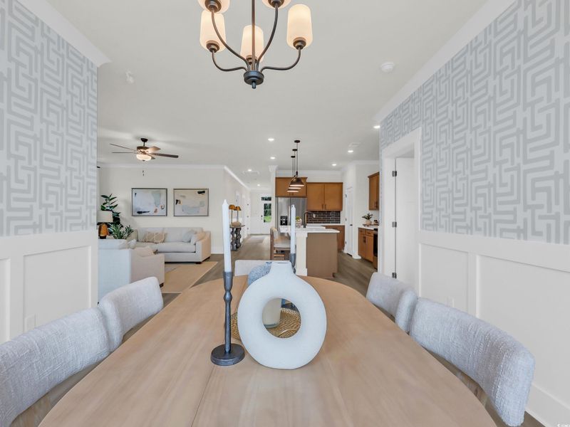 Dining room with wallpapered walls, wainscoting, a decorative wall, a chandelier, and recessed lighting Dining room with wallpapered walls, wainscoting, a decorative wall, a chandelier, and recessed lighting