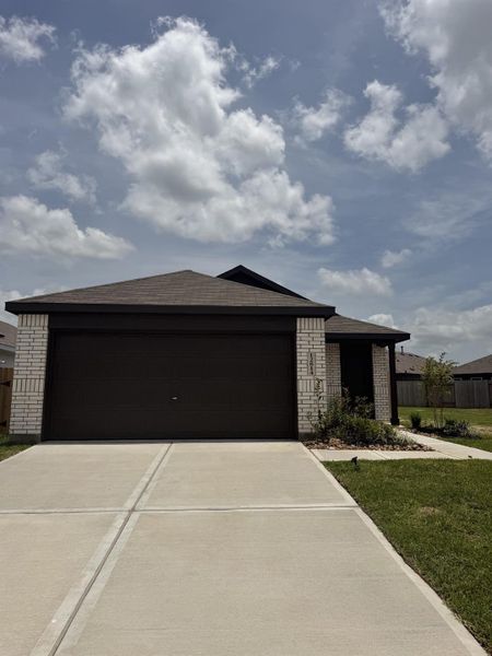Front exterior of a new home in Sweetgrass Village, Crosby, TX, highlighting curb appeal (Image 2).