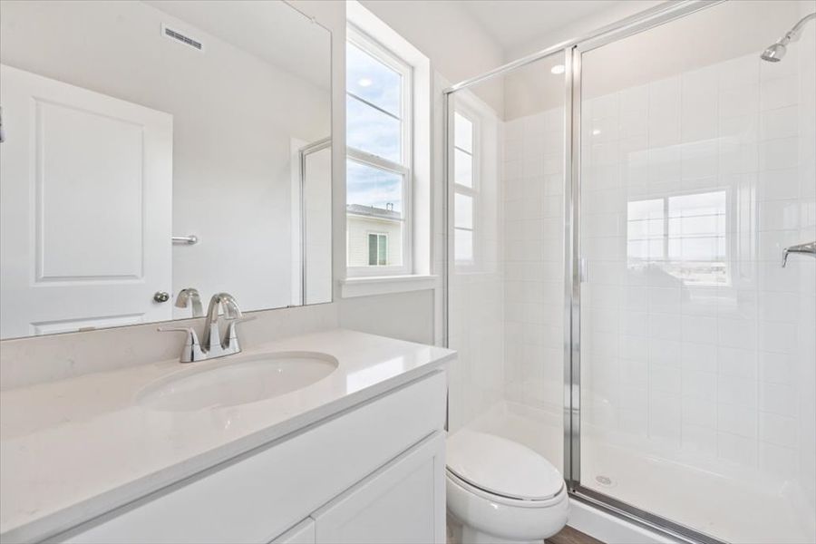 A bathroom with a glass shower. A bathroom with a glass shower.