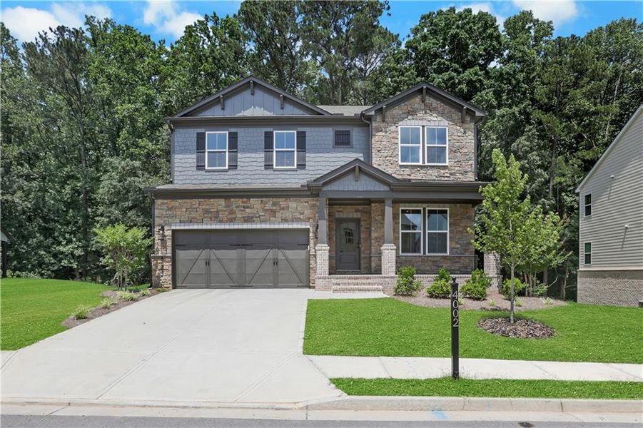 Front exterior of a new home in The Paddocks at Doc Hughes, Buford, GA, highlighting curb appeal (Image 24). Front exterior of a new home in The Paddocks at Doc Hughes, Buford, GA, highlighting curb appeal (Image 24).