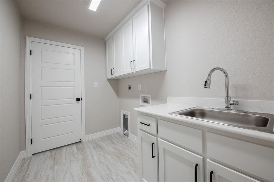 Laundry room with cabinet space, washer hookup, and electric dryer hookup