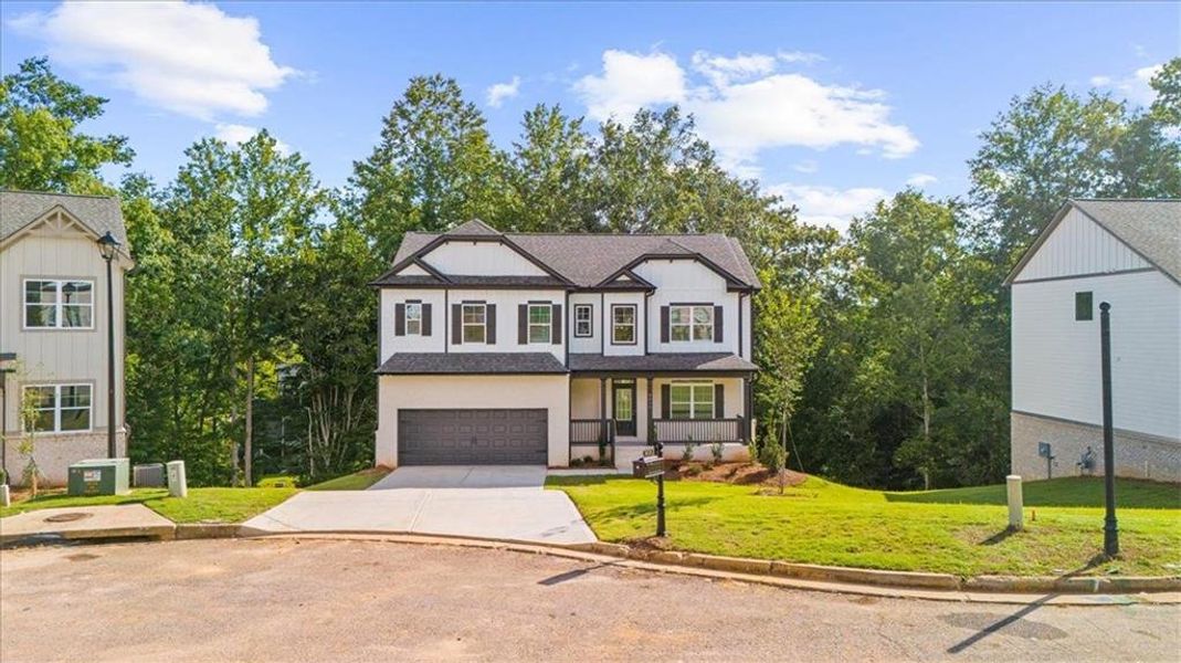 Front exterior of a new home in River Rock, Ball Ground, GA, highlighting curb appeal (Image 29).