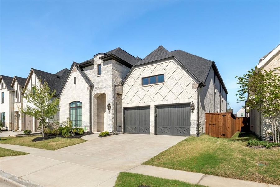 Front exterior of a new home in The Tribute 60', The Colony, TX, highlighting curb appeal (Image 24). Front exterior of a new home in The Tribute 60', The Colony, TX, highlighting curb appeal (Image 24).