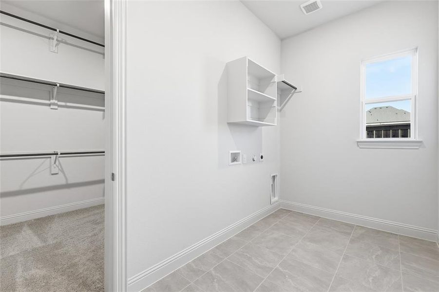 Laundry room with hookup for an electric dryer, hookup for a washing machine, and gas dryer hookup Laundry room with hookup for an electric dryer, hookup for a washing machine, and gas dryer hookup