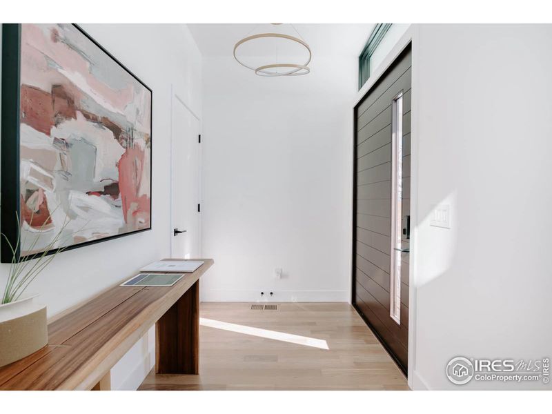 Foyer with 4.5' wide walnut pivot door