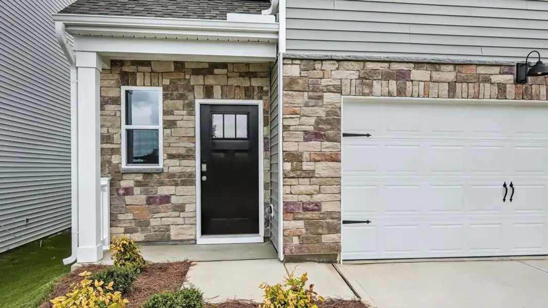 Exterior details and patio area of a home in The Grove at Matthews Landing, Fuquay Varina (Image 3).