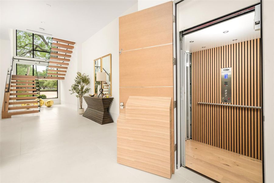 Private elevator serving all floors offers effortless convenience, seamlessly integrated into the home’s modern design.