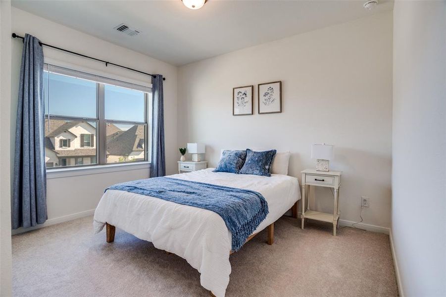 Bedroom with light carpet and baseboards