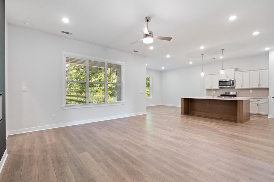 Open concept living space featuring wood-finish flooring, recessed lighting, and a modern ceiling fan