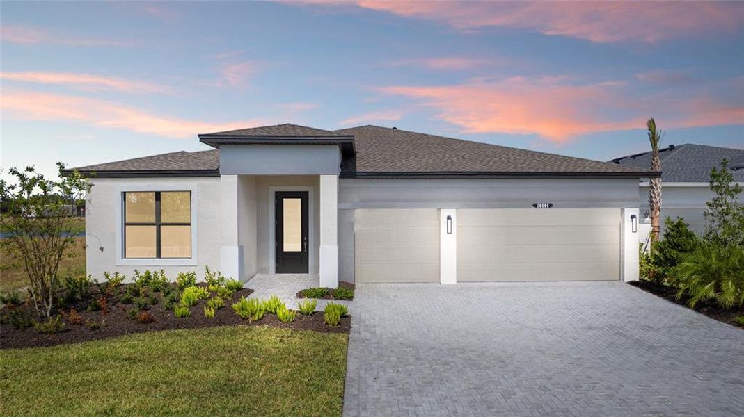 Front exterior of a new home in Woodland Preserve, Parrish, FL, highlighting curb appeal (Image 2).
