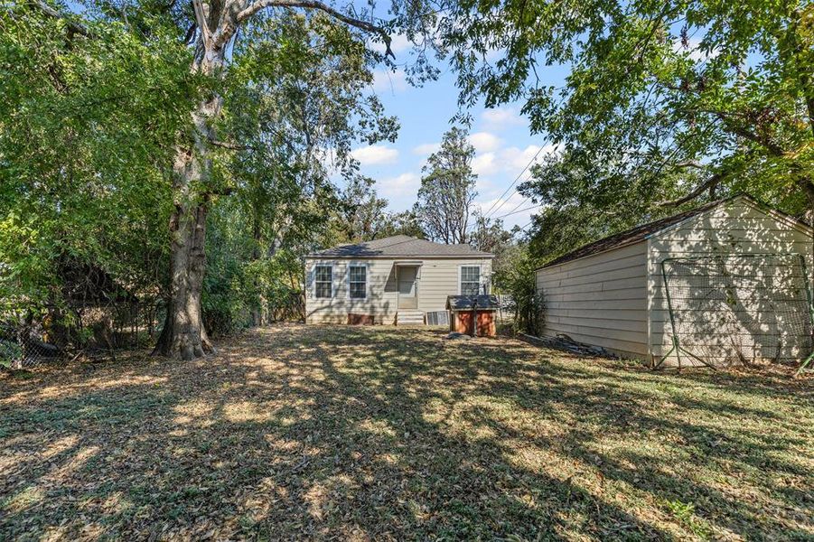Rear view of property featuring an outdoor structure