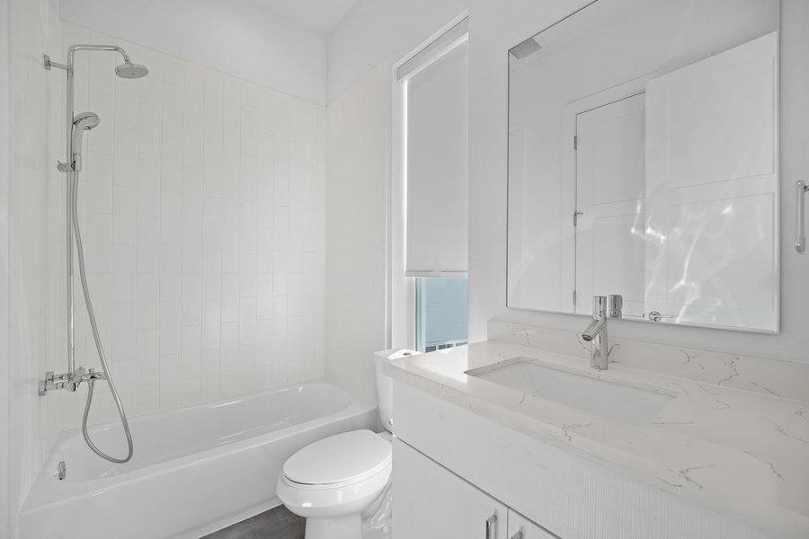 Bathroom featuring vanity and tub / shower combination