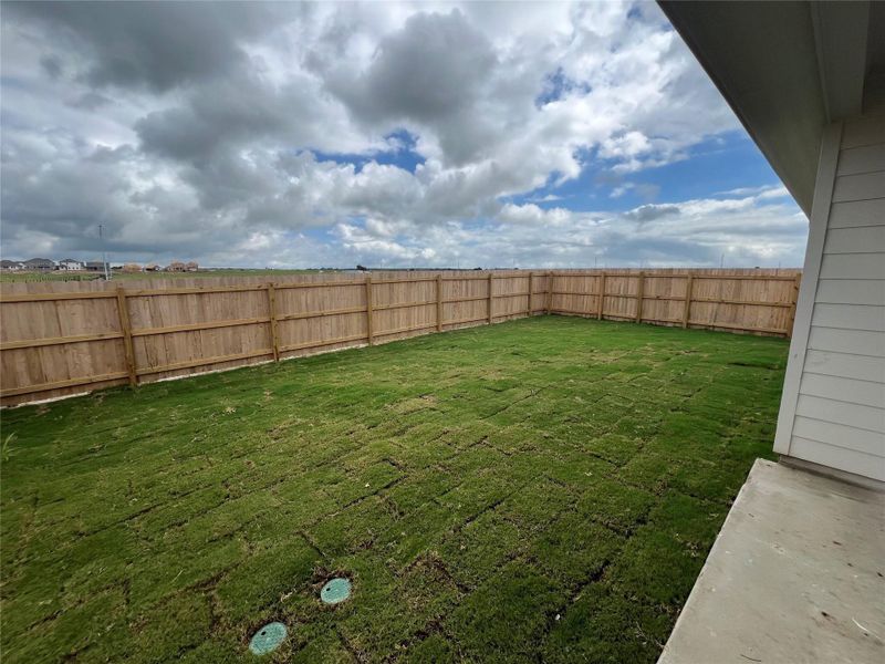 A spacious backyard with newly laid turf awaits your personal touch.