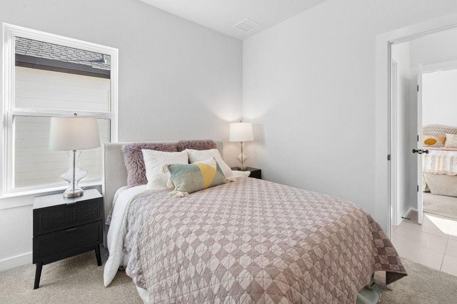 Bedroom with light colored carpet and baseboards Bedroom with light colored carpet and baseboards