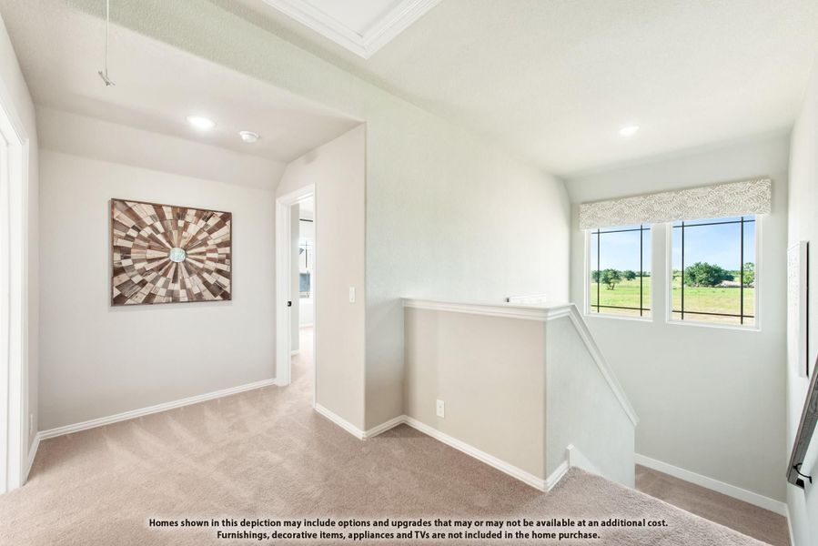 Upstairs hallway landing with carpet, staircase railing, and window overlooking green yard Upstairs hallway landing with carpet, staircase railing, and window overlooking green yard