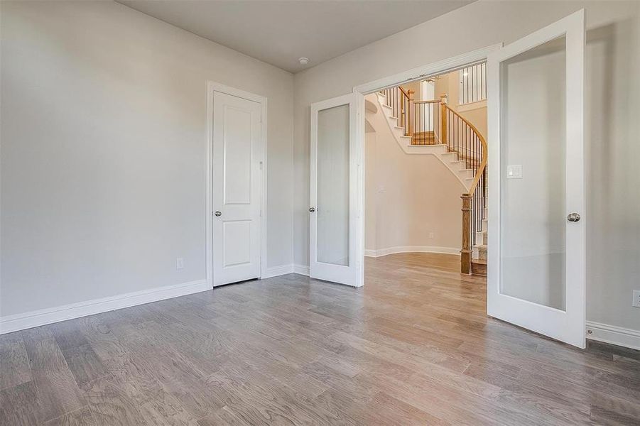 Unfurnished room featuring wood-type flooring