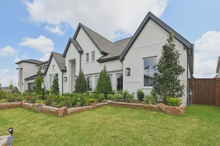Front exterior of a new home in Meridiana 60's, Manvel, TX, highlighting curb appeal (Image 24).