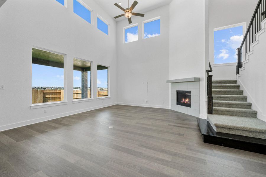 Family Room with soaring ceiling & fireplace