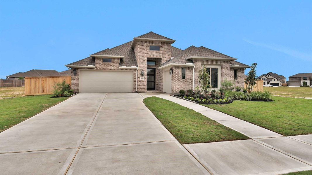 Front exterior of a new home in Valencia, Manvel, TX, highlighting curb appeal (Image 2).