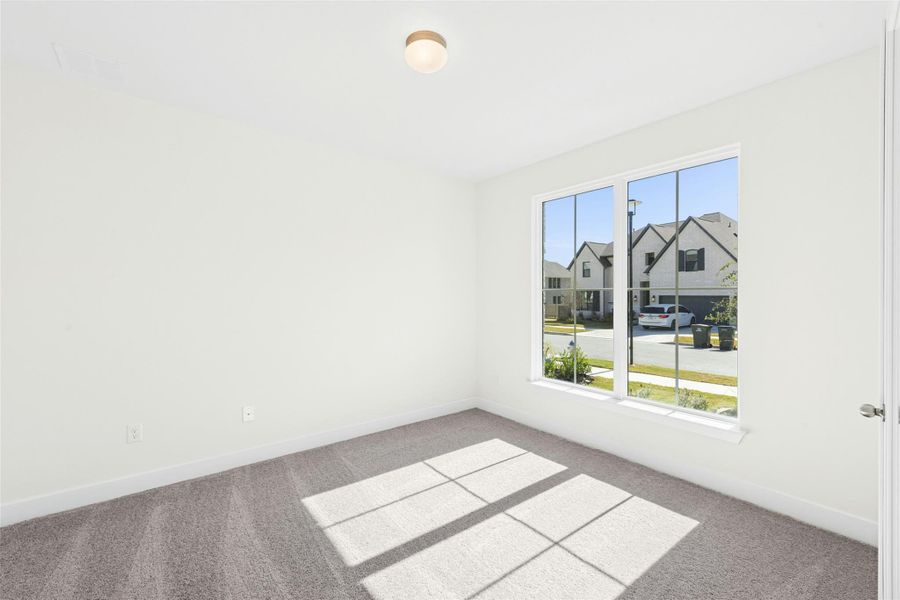 Unfurnished room featuring carpet floors and a residential view
