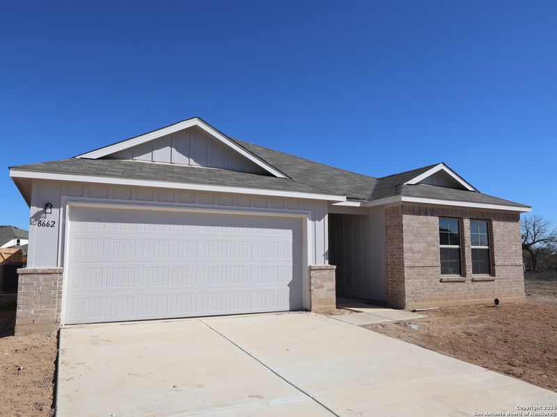 Front exterior of a new home in Greenspoint Heights, San Antonio, TX, highlighting curb appeal (Image 21).