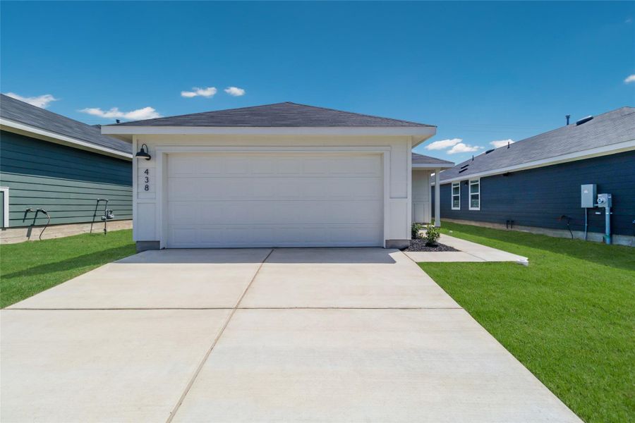 Front exterior of a new home in Watermill, Uhland, TX, highlighting curb appeal (Image 2).