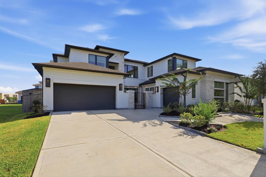 Front exterior of a new home in Sienna, Missouri City, TX, highlighting curb appeal (Image 24).