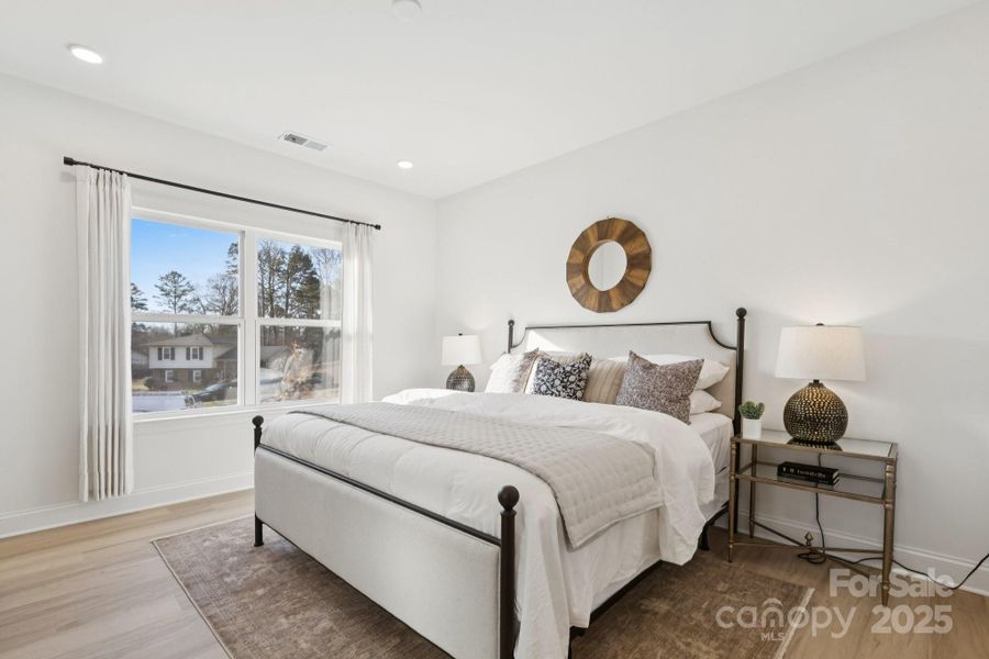 Large primary suite with massive walk-in closet and en suite bathroom with tiled shower wall