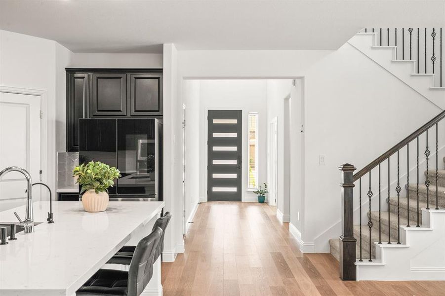Foyer featuring stairway and light wood finished floors