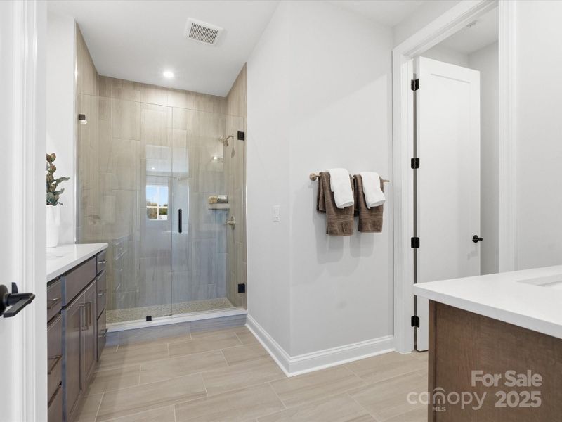 Primary En Suite Bath with Walk-In Shower and Modern Tile Design. *Model Photos | Actual Finishes, Structural Selections, and Orientation May Vary.