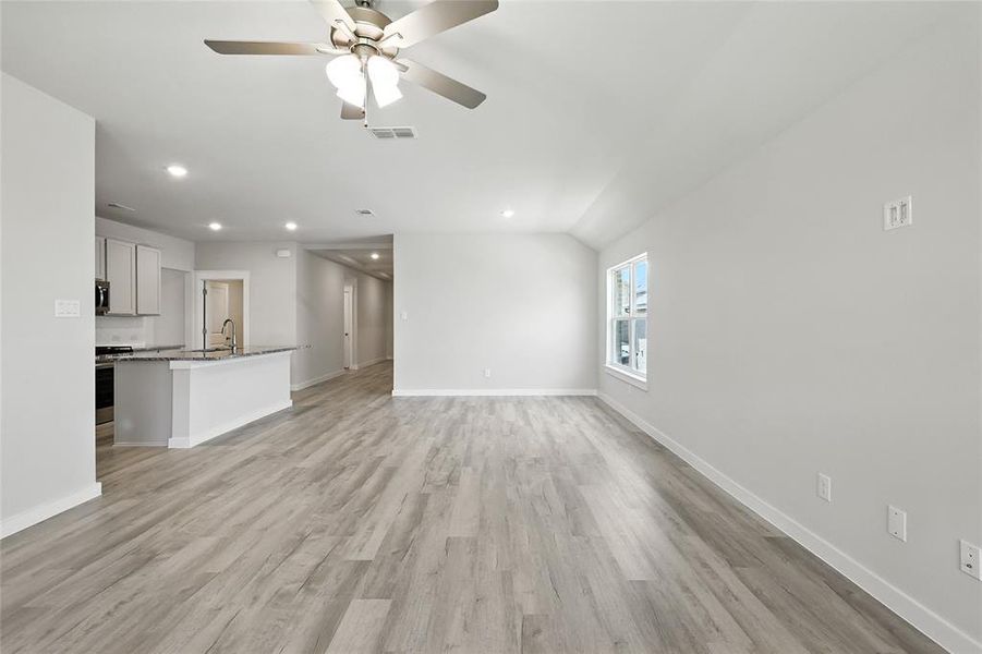 Unfurnished living room with recessed lighting, light wood-type flooring, and a ceiling fan
