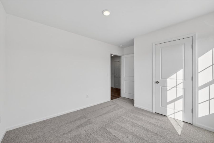 A hallway with white doors.