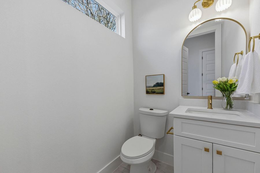 Half bath with vanity and toilet