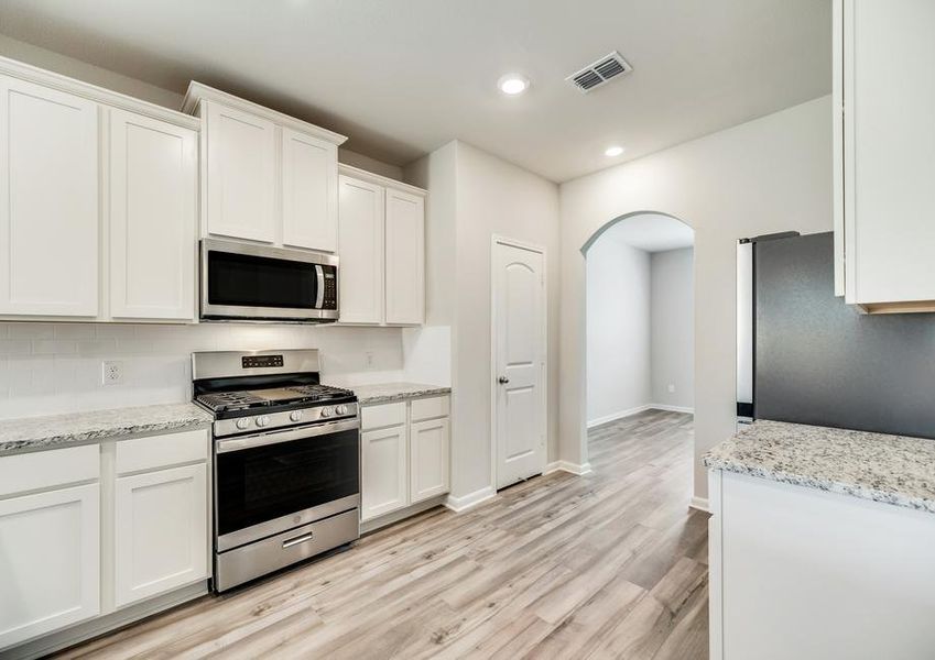 The kitchen is open to the formal dining room in this home.