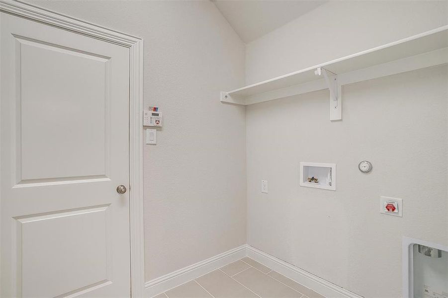 Laundry room with washer hookup, hookup for an electric dryer, tile patterned floors, and hookup for a gas dryer