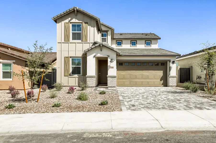 Front exterior of a new home in Teravalis, Buckeye, AZ, highlighting curb appeal (Image 1). Front exterior of a new home in Teravalis, Buckeye, AZ, highlighting curb appeal (Image 1).