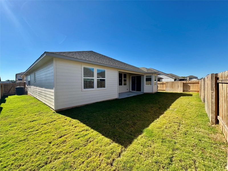 Back of house with a patio area, a fenced backyard, and a shingled roof