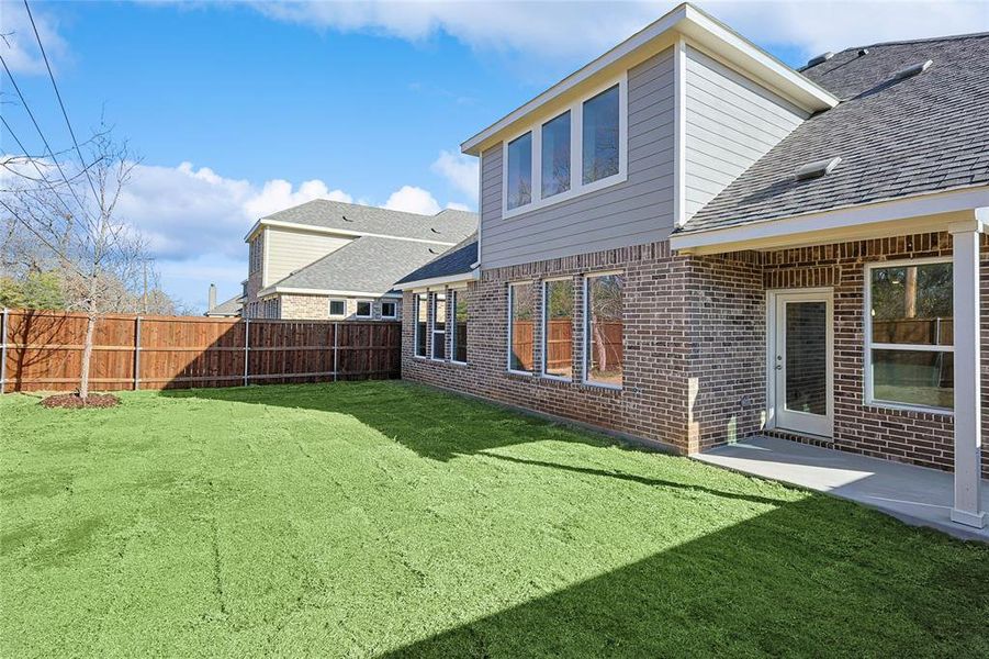 Rear view of property with a yard