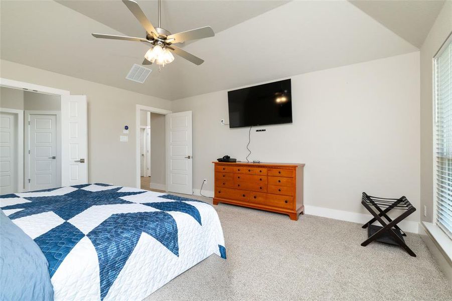 Carpeted bedroom with baseboards and ceiling fan