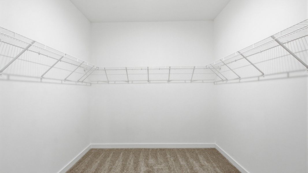 Sizeable walk-in closet with racks for storage options