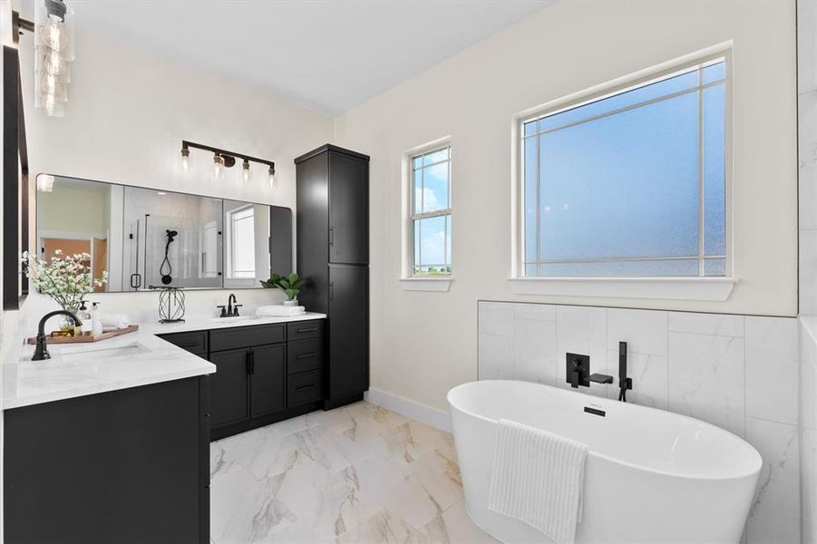 Full bathroom with vanity, marble finish floors, a soaking tub, tile walls, and a shower Full bathroom with vanity, marble finish floors, a soaking tub, tile walls, and a shower
