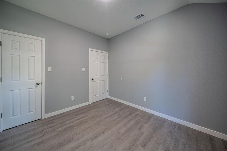 Unfurnished room with dark wood-type flooring and baseboards Unfurnished room with dark wood-type flooring and baseboards