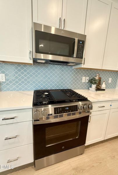 Gas oven and vent microwave above