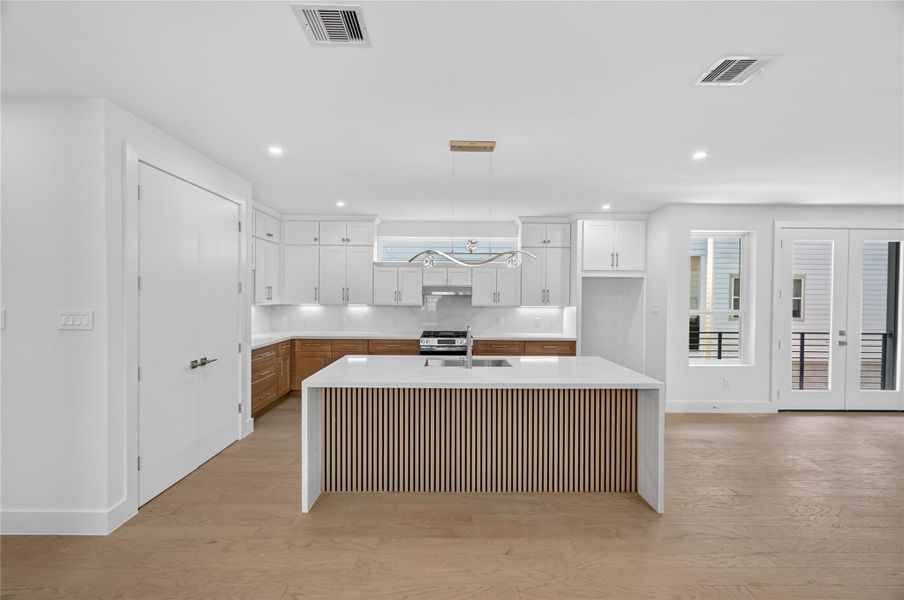 Spacious kitchen located on the second floor, oversized island with acoustic panneling.