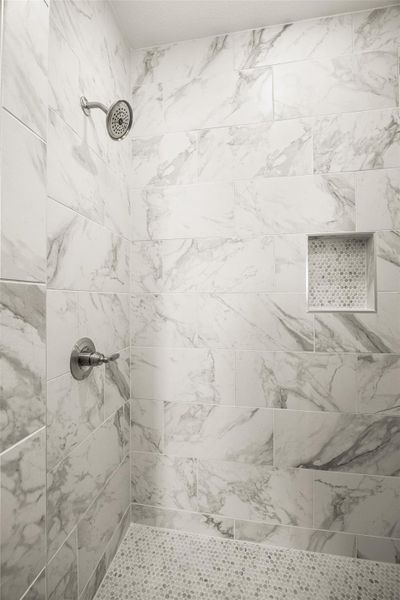 Full bathroom featuring a tile shower