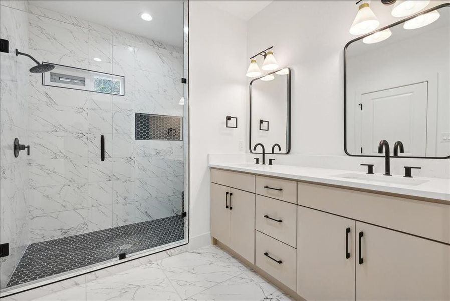 Bathroom featuring vanity and a shower with door