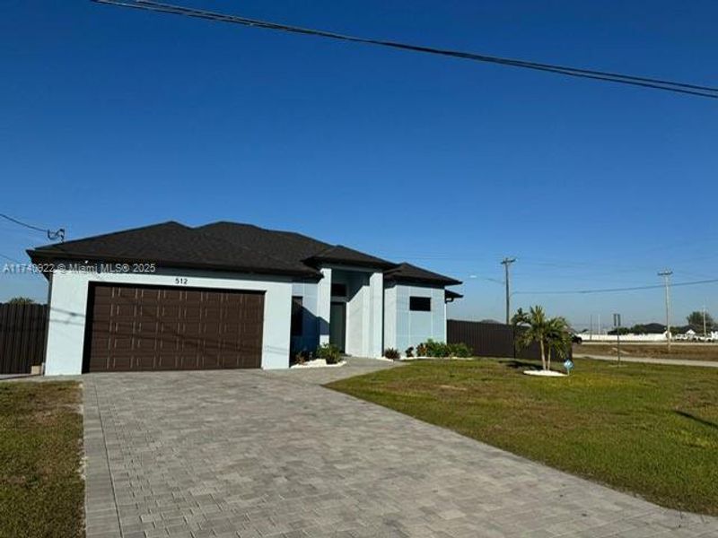 Front exterior of a new home in , Cape Coral, FL, highlighting curb appeal (Image 1).